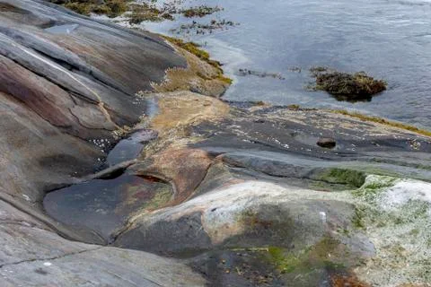 Beginning of a pothole created by tidal current in Northern Norway. Stock Photos