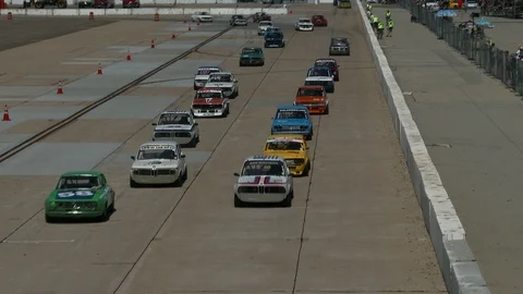 Beginning of race with flagman waving the start. Stock Footage 89438016
