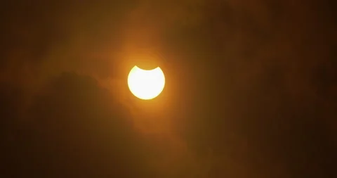 Beginning of a solar eclipse revealed through clouds, October 14th, 2023. Stock Footage 253367552