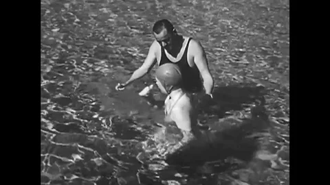 A beginning swimmer learns the back float, in seawater, during a swimming Video stock 137521514
