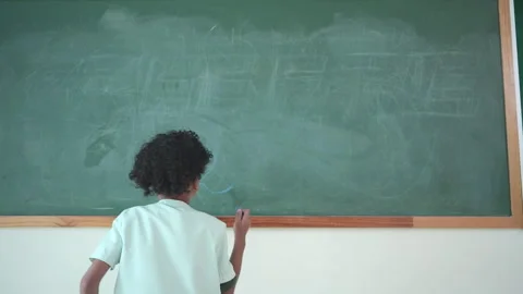 Before beginning their academic day, Children like writing on the chalkboard Stock Footage 285252573