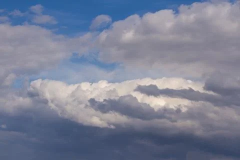 The beginning of a thunderstorm in the blue sky, background, texture. Stock Photos
