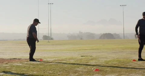 Beginning training partners rotating side shuffling and lunging around three Stock Footage 345123209
