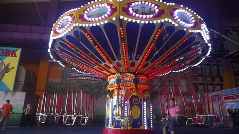 The beginning of two children playing the Paris Swing game at Transmart Padang Stock Footage 293995029