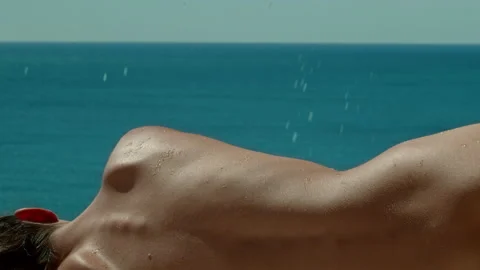 Beginning of water falling on woman's back in the sun. Stock Footage 161470597