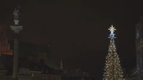 At the beginning we can see the top of a large illuminated Christmas tree, wh Stock Footage 108518429