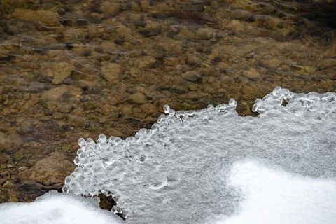 Beginning of the winter, Ice forms on the vegetation across the river. Stock Photos