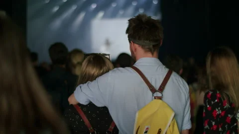 Behind the back shot of a young couple at a concert. 4K Stock Footage 221552044