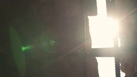 Behind the bars of a prison window the sun shines brightly. Slow motion Close-up Stock-Footage 125214820