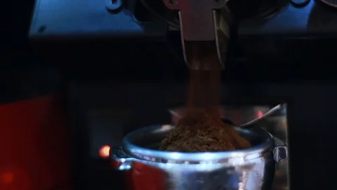 Behind the cafe bar coffee grinder pours ground coffee in holder Stock Footage 100143901