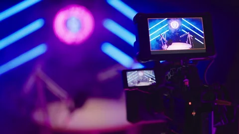Behind the camera recording podcast studio in blue neon tube studio LIVE ON AIR Stock Footage 303420588