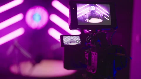 Behind the camera recording podcast studio in pink neon tube studio LIVE ON AIR Stock Footage 303420589