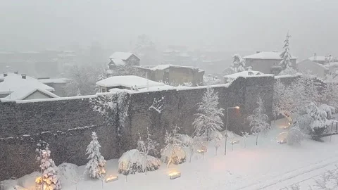 Behind the castle the old city is under snowfall Stock Footage 134702322