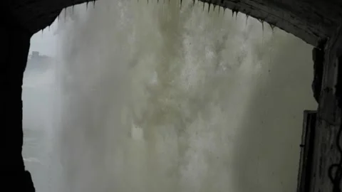 Behind the falls view of water falling Niagara falls looking at American falls Stock Footage 229600354
