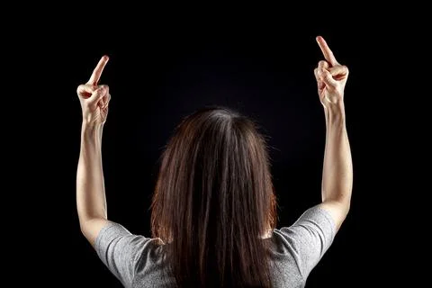 Behind the head view of a young caucasian woman with long brown hair wearing  Stock Photos