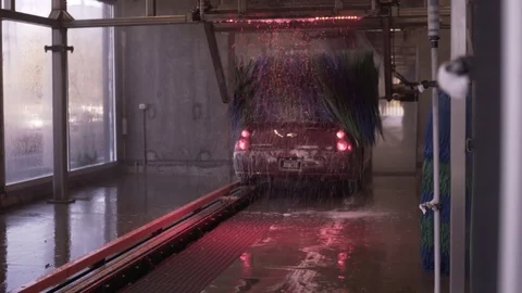 Behind Red Car Driving Through Car Wash Brush Video stock 87895261