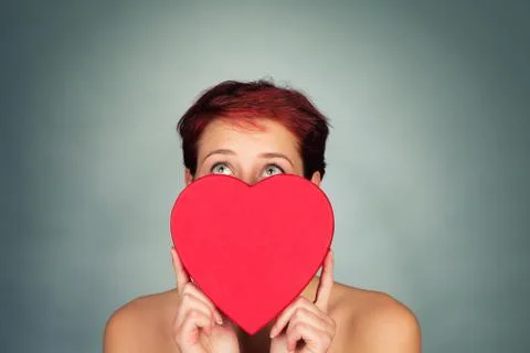 Behind a red heart looking up Stock Photos