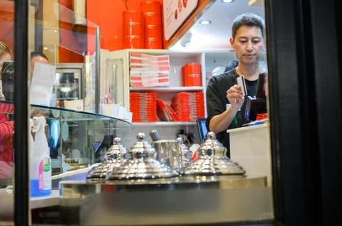 Behind the Scenes: A Man at Work in a Cookie Store Stock Photos