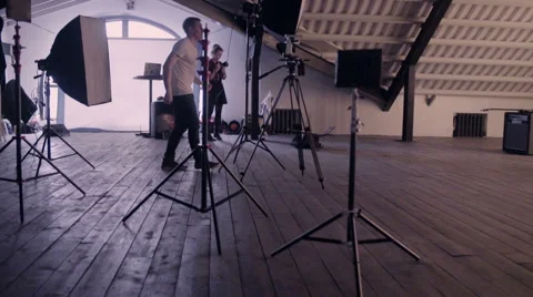 Behind the scenes. An operator check lights and film a scene of musical video wi Stock Footage 62112231