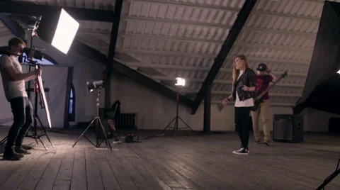 Behind the scenes. An operator film a scene of musical video with rock band on s Stock Footage 62114059