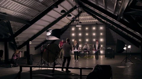 Behind the scenes. An operator film a scene of musical video with rock band on s Stock Footage 62114149