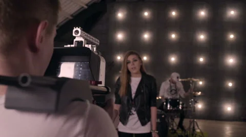Behind the scenes. An operator film a scene of musical video with rock band on s Stock Footage 62114352