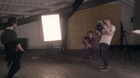 Behind the scenes. An operator film a scene of musical video with rock band on s Stock Footage 62114657