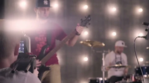 Behind the scenes. An operator film a scene of musical video with rock band on s Stock Footage 62114767