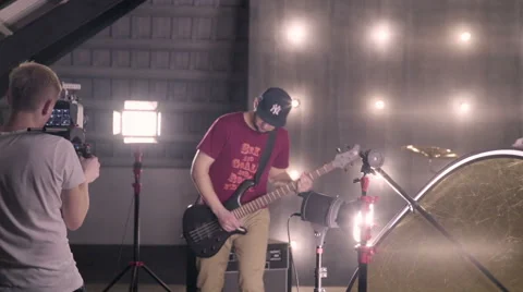Behind the scenes. An operator film a scene of musical video with rock band on s Stock Footage 62114993