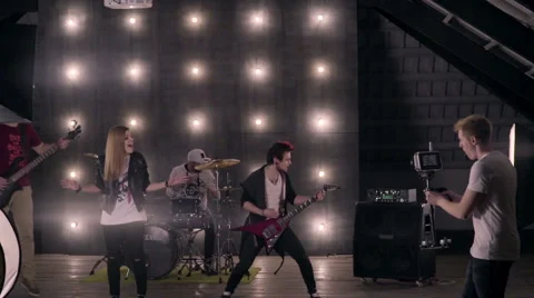 Behind the scenes. An operator film a scene of musical video with rock band on s Stock Footage 62115226