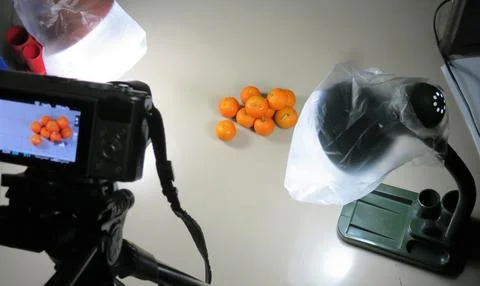 Behind the Scenes of an orange shoot in a Simple Mini Studio Setup Stock Photos