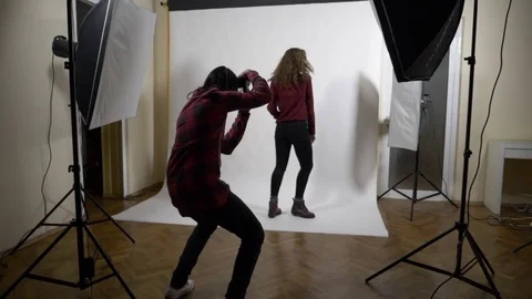 Behind the scenes photo shoot session of a blonde curly slim model for a famo Stock Footage 83181325