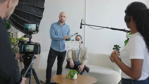 Behind the Scenes on a Video Production Set. Director Uses Clapper Slate Video stock 194509815