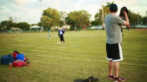 Behind shot of Man pitching to a kid during Baseball practice Stock Footage 47713146