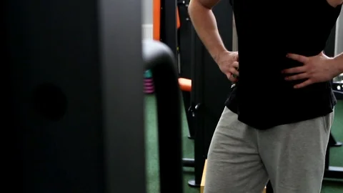 Behind the simulator is an athlete who stretches his legs Stock Footage 114292668