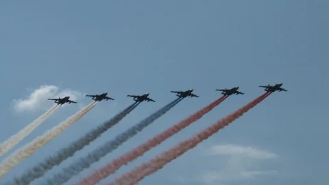 Behind Six Su-25 attack aircraft (Frog)  are smoke in color of Russian flag. Stock Footage 115012798