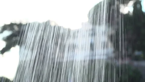 Behind small waterfall looking at a villa  Stock Footage 95935300