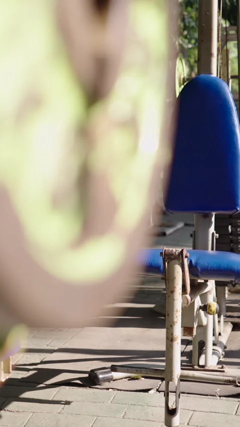 Behind some weight discs a very old gymnasium is shown Stock Footage 264776334
