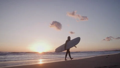 Behind Surfer Looking out at Ocean at Sunset Stock Footage 270393806