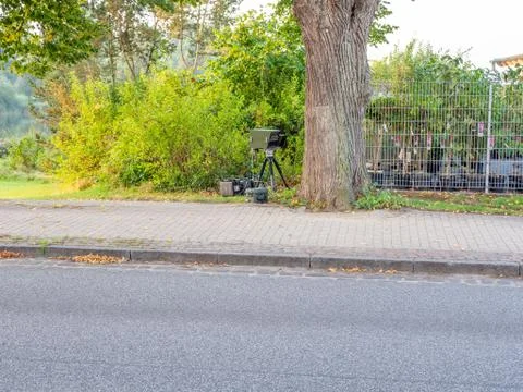 Behind a tree is radar trap for speed monitoring Stock Photos