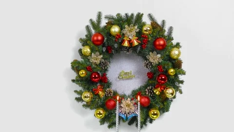 Behind two candles weighs a large Christmas wreath Stock Footage 166344550