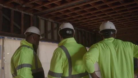Behind View Of Construction Workers Talking On Job Site Stock Footage 270389296