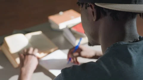 Behind View Man Taking Notes from Book in Library Stock Footage 318703195
