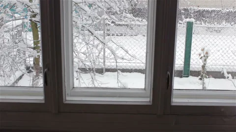 Behind the window the snow falls Vídeos de archivo 96143194