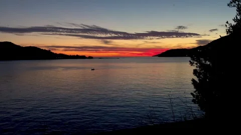 Behold the stunning sunset casting vibrant hues over tranquil waters and Stock Footage 321500217