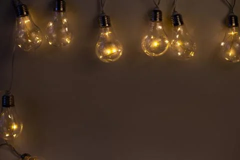 Beige background of bright light bulbs Stock Photos
