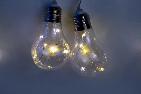 Beige background of bright light bulbs Stock Photos