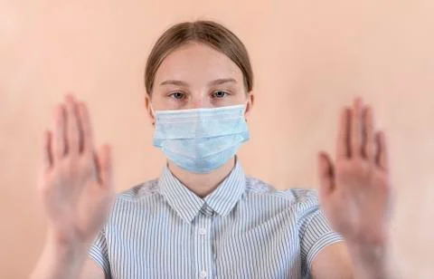 Beige background, close-up focus face, teenage girl medical one, stop gesture Stock Photos