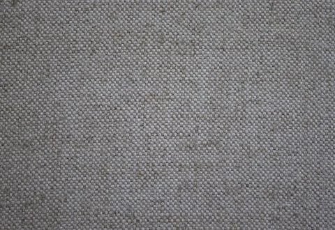 Beige background from a textile material with a wicker pattern, close-up. Stock Photos