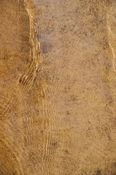 Beige background of the water surface. The texture of water with splashes and Stock-Fotos